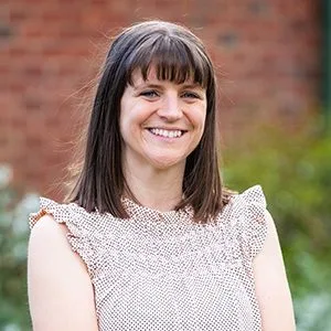 dietitian with white top with plant on background 1