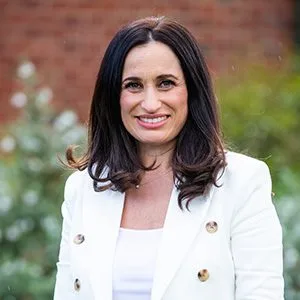 dietitian with white top with plant on background