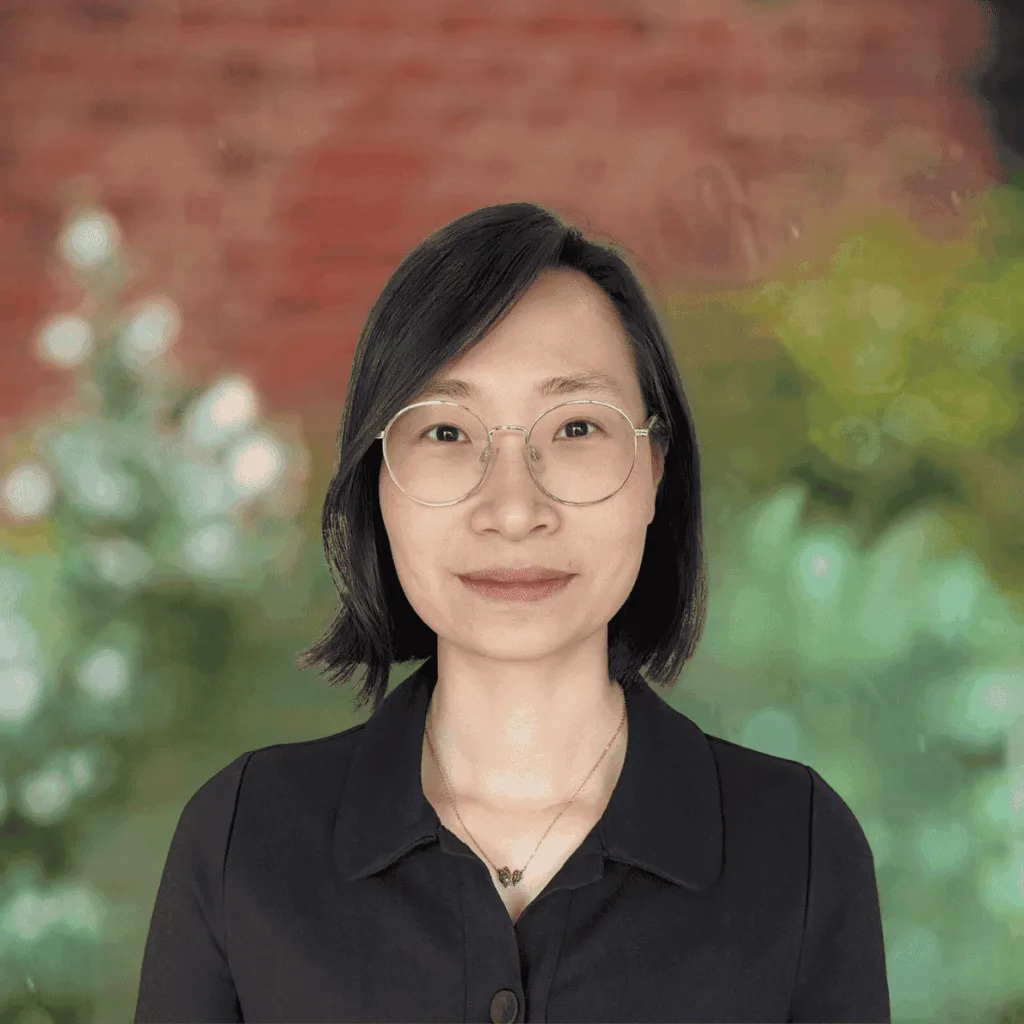 Nutrition Health & Wellbeing dietitian wearing glasses against a leafy background