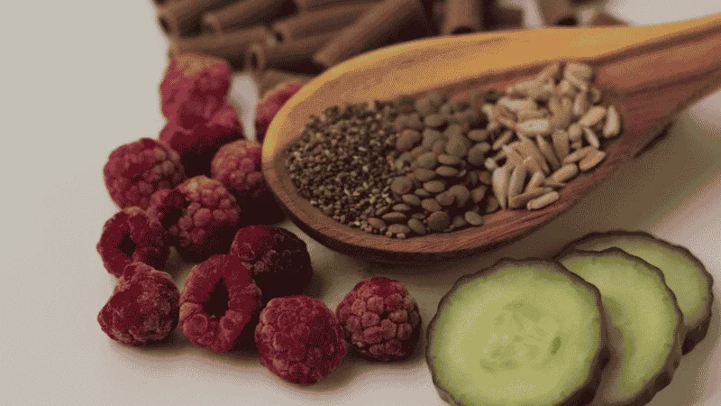 Bowls of berries, whole grains and seeds viewed from above