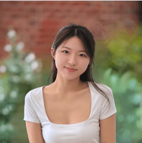 Nutrition Health & Wellbeing dietitian in a white top with a garden behind her
